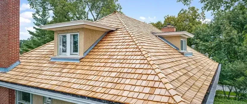 Aerial view of a charming home with a wooden shingle roof Aerial view of a charming home with a wooden shingle roof