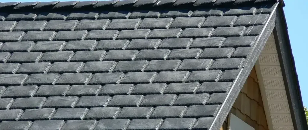 Close up of a sloped roof featuring textured black shingles Close-up of a sloped roof featuring textured black shingles