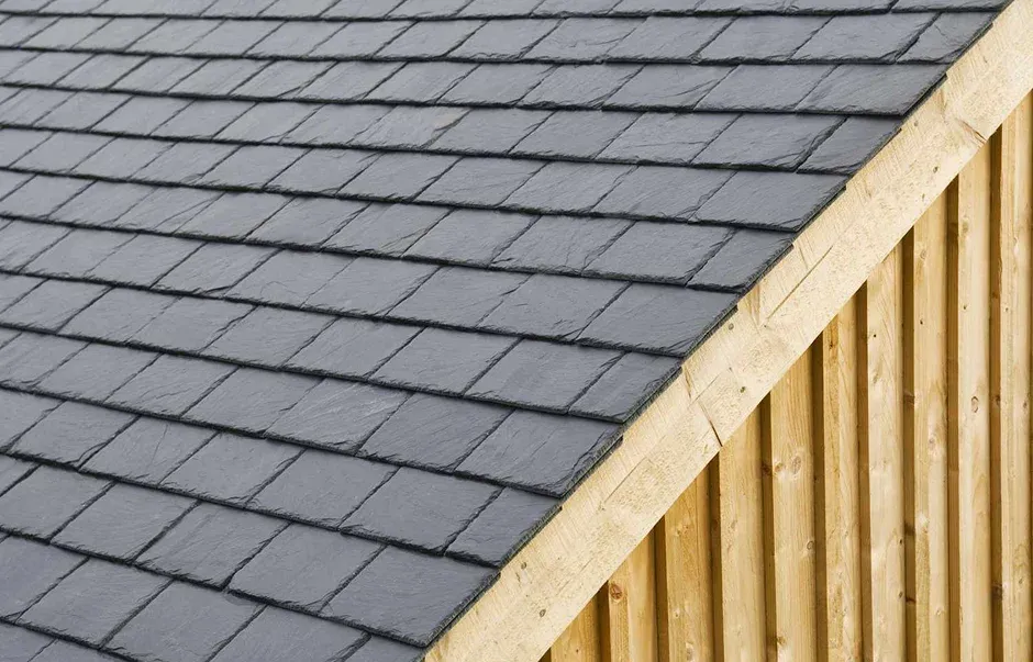 Close up of a slate roof with dark gray tiles Close-up of a slate roof with dark gray tiles